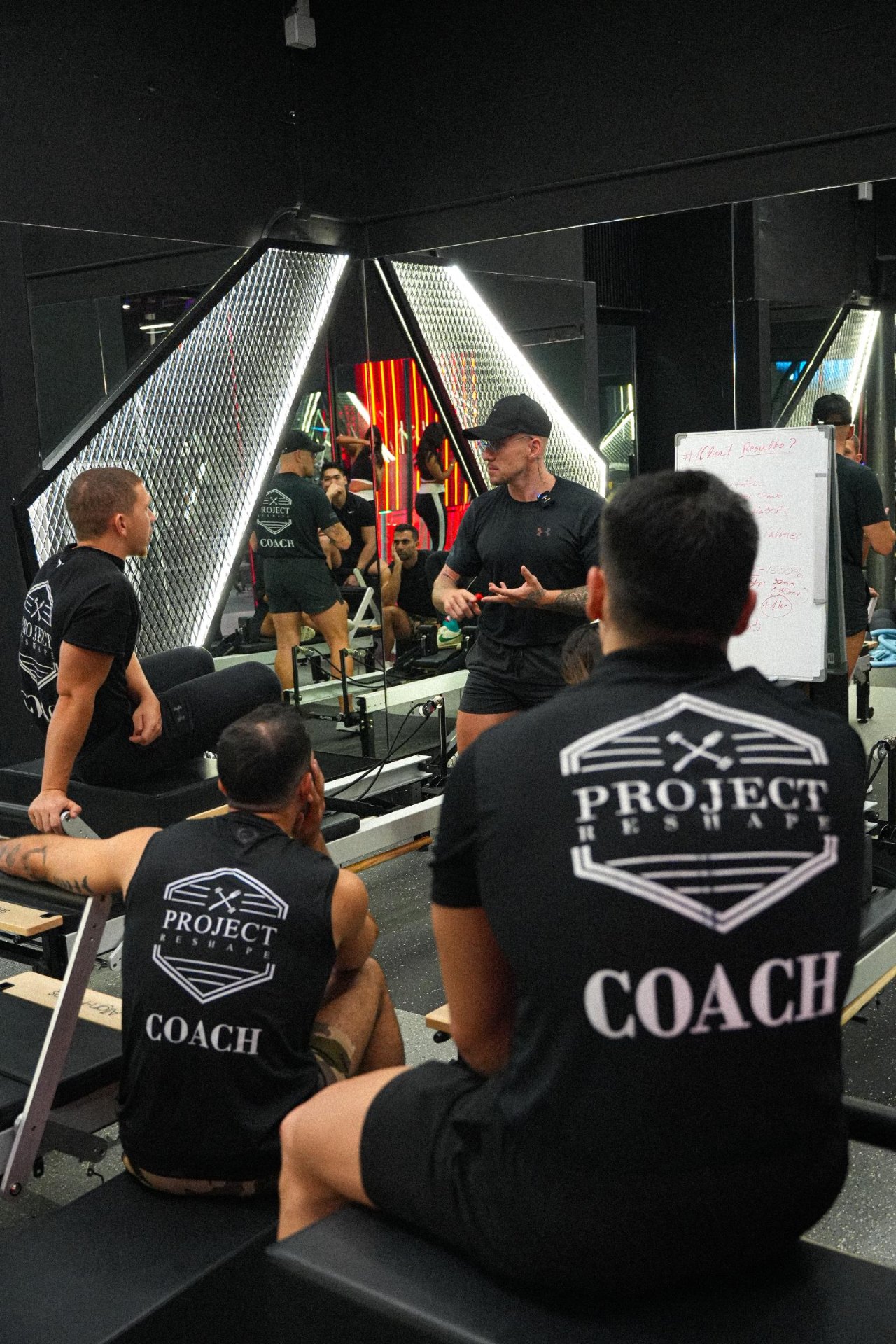 Project Reshape coaches in a team briefing on client results